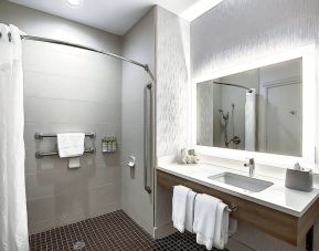 Day use guest bathroom with shower and toiletries at Holiday Inn Express & Suites Airport-Calgary.