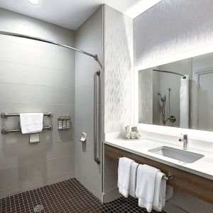 Day use guest bathroom with shower and toiletries at Holiday Inn Express & Suites Airport-Calgary.