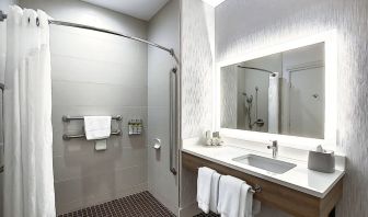 Day use guest bathroom with shower and toiletries at Holiday Inn Express & Suites Airport-Calgary.