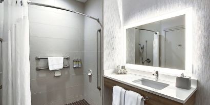 Day use guest bathroom with shower and toiletries at Holiday Inn Express & Suites Airport-Calgary.