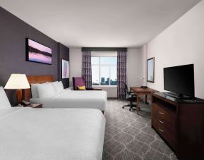 Comfortable twin room with TV, work desk and private bathroom at Hilton Garden Inn Calgary Airport.