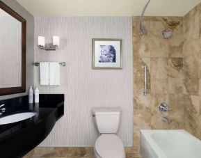 Day use guest bathroom with shower and tub at Hilton Garden Inn Calgary Airport.