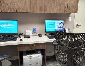 Business center with computers, printer, phone and ergonomic chairs at Hilton Garden Inn Calgary Airport.