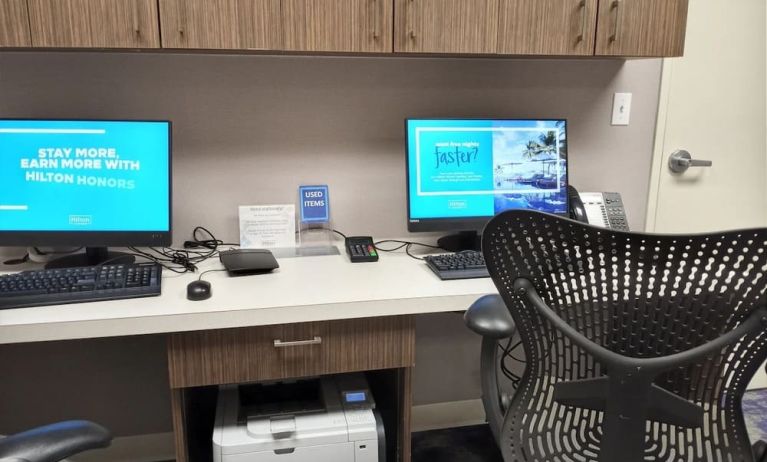 Business center with computers, printer, phone and ergonomic chairs at Hilton Garden Inn Calgary Airport.