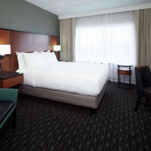 Day use room with TV, sofa, work desk and private bathroom at DoubleTree By Hilton Montreal Airport.