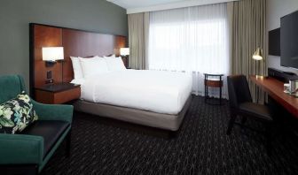 Day use room with TV, sofa, work desk and private bathroom at DoubleTree By Hilton Montreal Airport.