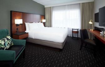 Day use room with TV, sofa, work desk and private bathroom at DoubleTree By Hilton Montreal Airport.