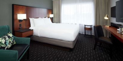 Day use room with TV, sofa, work desk and private bathroom at DoubleTree By Hilton Montreal Airport.