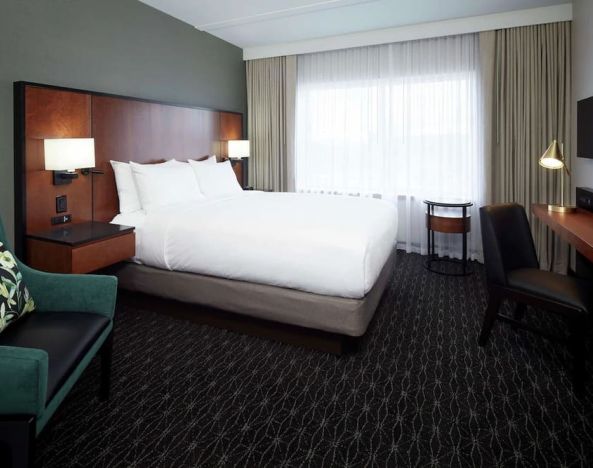 Day use room with TV, sofa, work desk and private bathroom at DoubleTree By Hilton Montreal Airport.