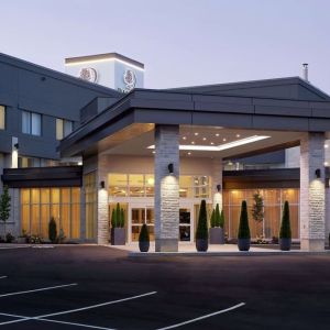 Hotel entrance and parking area at DoubleTree By Hilton Montreal Airport.