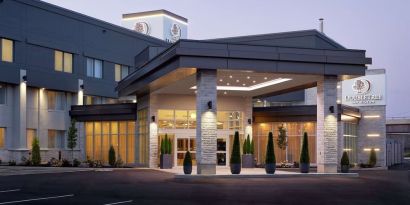 Hotel entrance and parking area at DoubleTree By Hilton Montreal Airport.