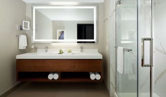 Private guest bathroom with shower and toiletries at DoubleTree By Hilton Montreal Airport.