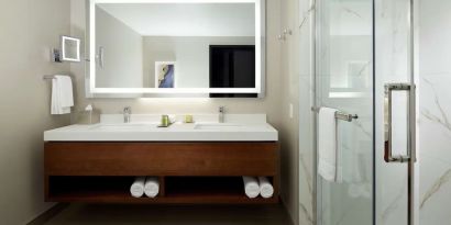 Private guest bathroom with shower and toiletries at DoubleTree By Hilton Montreal Airport.