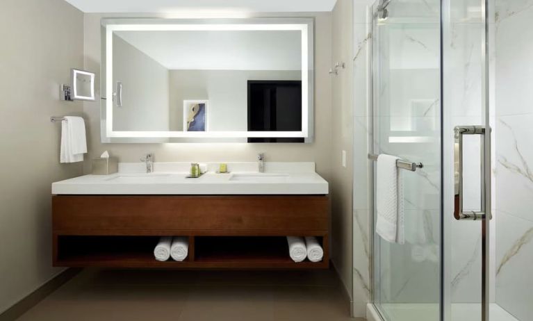 Private guest bathroom with shower and toiletries at DoubleTree By Hilton Montreal Airport.