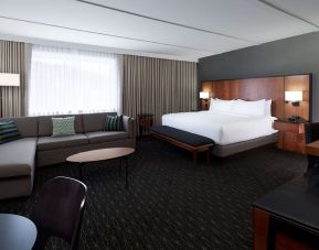 Bright and spacious studio suite with living area, workspace and private bathroom at DoubleTree By Hilton Montreal Airport.