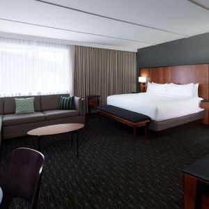 Bright and spacious studio suite with living area, workspace and private bathroom at DoubleTree By Hilton Montreal Airport.