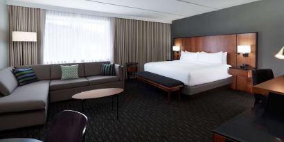 Bright and spacious studio suite with living area, workspace and private bathroom at DoubleTree By Hilton Montreal Airport.