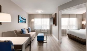 Bright and spacious studio suite with living area and work desk at the Embassy Suites by Hilton Montreal Airport.