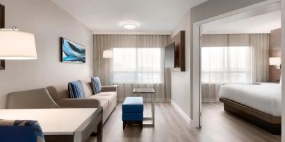 Bright and spacious studio suite with living area and work desk at the Embassy Suites by Hilton Montreal Airport.