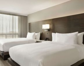 Twin room with private bathroom at the Embassy Suites by Hilton Montreal Airport.