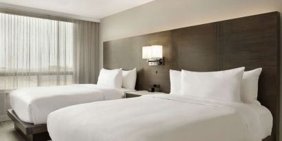 Twin room with private bathroom at the Embassy Suites by Hilton Montreal Airport.