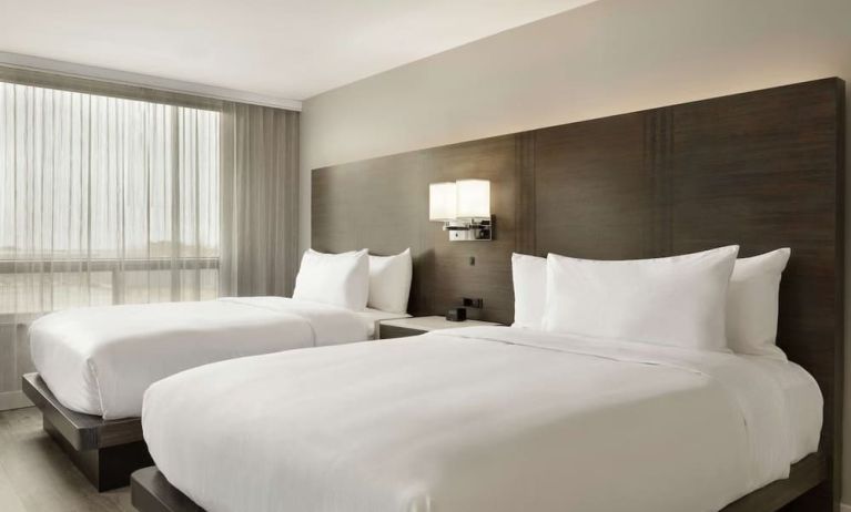 Twin room with private bathroom at the Embassy Suites by Hilton Montreal Airport.