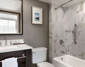 Private bathroom with tub at the Embassy Suites by Hilton Montreal Airport.