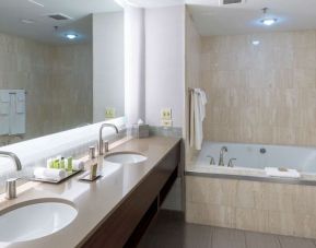 Private bathroom with tub and toiletries at the Hilton Saint John.