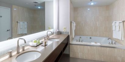 Private bathroom with tub and toiletries at the Hilton Saint John.