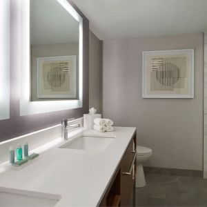 Guest bathroom with shower at Courtyard By Marriott Kitchener.