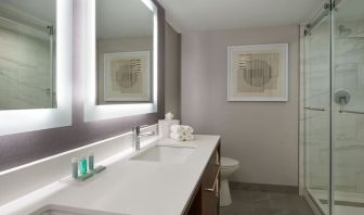 Guest bathroom with shower at Courtyard By Marriott Kitchener.