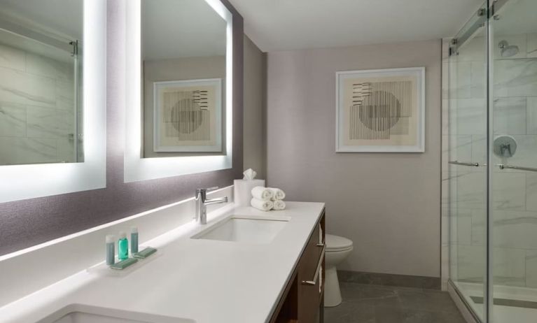 Guest bathroom with shower at Courtyard By Marriott Kitchener.