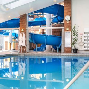 Indoor pool with spiral slide at Hilton Mississauga Meadowvale.