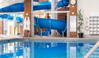 Indoor pool with spiral slide at Hilton Mississauga Meadowvale.