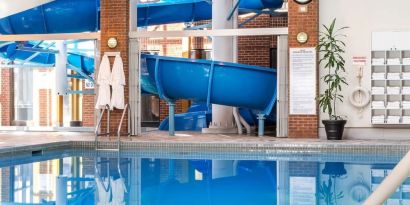 Indoor pool with spiral slide at Hilton Mississauga Meadowvale.