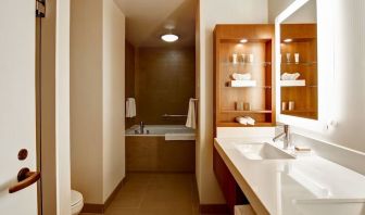 Private guest bathroom with tub and toiletries at Hilton Mississauga Meadowvale.