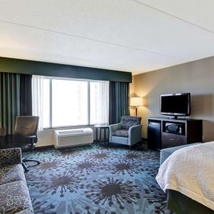 Day use room with TV, work desk and lounge area at Hampton Inn By Hilton Toronto Airport Corporate Centre.