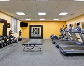 Fully equipped fitness center with treadmills and weights at the Hampton Inn by Hilton Toronto Airport Corporate Centre.