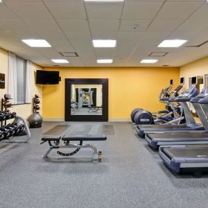 Fully equipped fitness center with treadmills and weights at the Hampton Inn by Hilton Toronto Airport Corporate Centre.