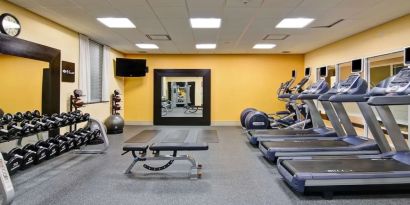 Fully equipped fitness center with treadmills and weights at the Hampton Inn by Hilton Toronto Airport Corporate Centre.