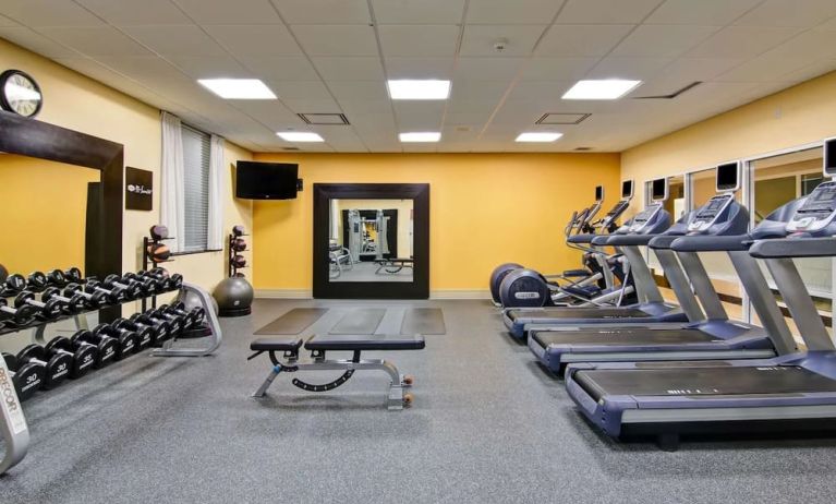 Fully equipped fitness center with treadmills and weights at the Hampton Inn by Hilton Toronto Airport Corporate Centre.