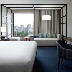 Day use room with work desk, lounge area and window view at DoubleTree By Hilton Montreal.