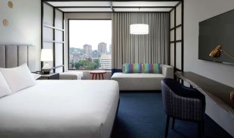 Day use room with work desk, lounge area and window view at DoubleTree By Hilton Montreal.