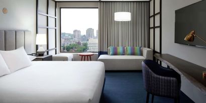 Day use room with work desk, lounge area and window view at DoubleTree By Hilton Montreal.