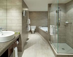 Private guest bathroom with shower, tub and free toiletries at DoubleTree By Hilton Montreal.