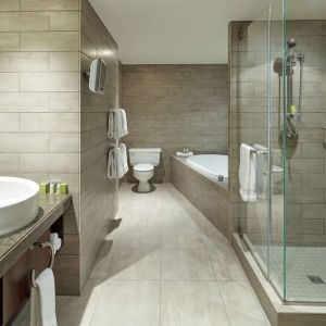 Private guest bathroom with shower, tub and free toiletries at DoubleTree By Hilton Montreal.