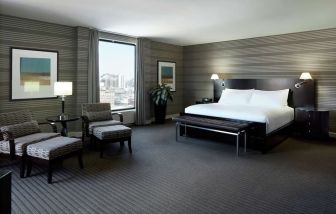 Day use room with work desk, lounge area and private bathroom at DoubleTree By Hilton Montreal.