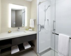 Private guest bathroom with shower and free toiletries at DoubleTree By Hilton Montreal.