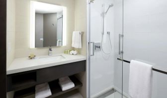 Private guest bathroom with shower and free toiletries at DoubleTree By Hilton Montreal.