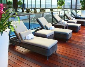 Relaxing indoor pool with lounge chairs at DoubleTree By Hilton Montreal.